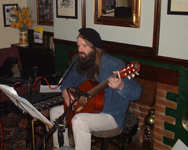 some dumb hippy playing a guitar and yarping