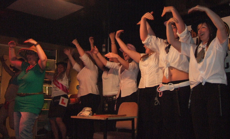 A group of girls standing in a line dressed as cops.